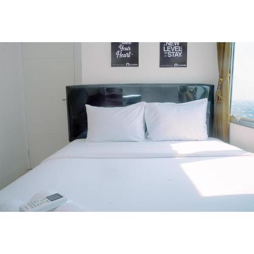 2BR Fully Furnished Minimalist Bassura City Apartment By Travelio