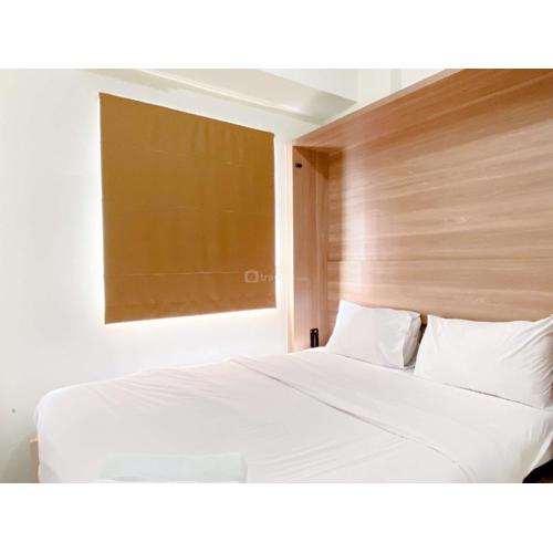 Comfort Designed 2BR Green Pramuka City Apartment By Travelio