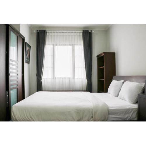 Cozy Living and Modern 2BR Puri Garden Apartment By Travelio