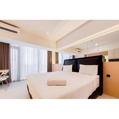 Fancy and Nice Studio Apartment Carstensz Residence By Travelio