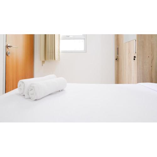 Homey 2BR at Puncak Permai Apartment By Travelio