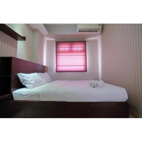 Homey and Relaxing 2BR Green Pramuka City Apartment By Travelio