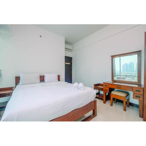 Homey and Warm 1BR Apartment at Ambassade Residence By Travelio