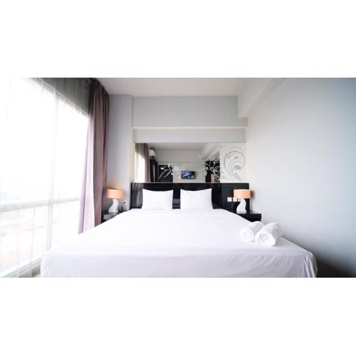 Homey Studio No Kitchen at Grand Darmo Suite Apartment By Travelio