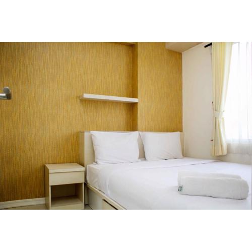 Minimalist and Warm 2BR Bassura City Apartment By Travelio