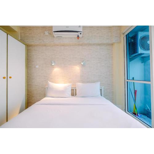 Minimalist Studio with Great City View at Tifolia Apartment By Travelio