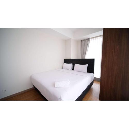 Simple and Clean 2BR at Grand Sungkono Lagoon Apartment By Travelio