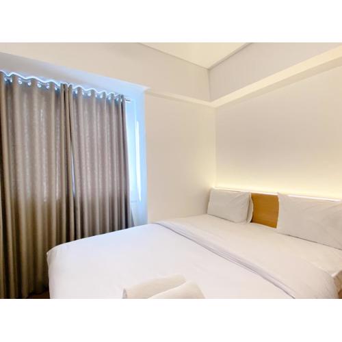 Spacious and Homey 2BR with Work Space at Meikarta Apartment By Travelio