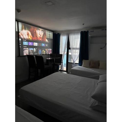 Studio w projector Wifi Netflix and pool access in ADB Tower Ortigas CBD